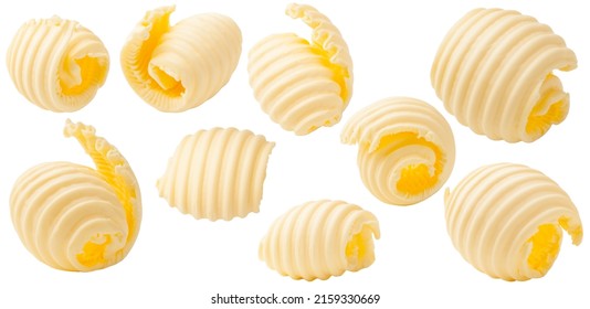 Los rizos de mantequilla se acumulan en un fondo blanco. Conjunto de trozos de mantequilla.