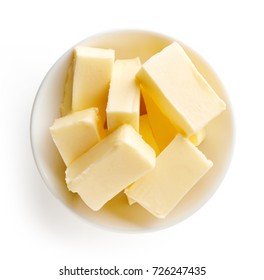 Butter Pieces In Bowl Isolated On White Background, Top View
