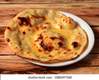 Butter roti, isolated over a rustic wooden background, selective focus