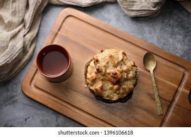 Butter Scotch On A Wooden Plate And Stone Background