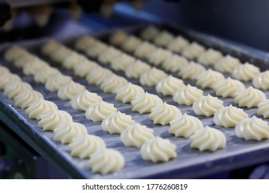 Butter Swirl Whipped Shortbread Cookies On The Tray At The Production Line. Selective Focus.