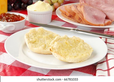 A Buttered English Muffin With Jelly And Ham