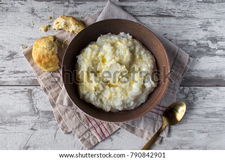 buttered grits with biscuits in rustic setting top view