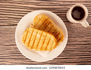 Buttered Toast on Plate with Coffee Cup, Breakfast, Top View (Brazilian Pao na Chapa) - Powered by Shutterstock