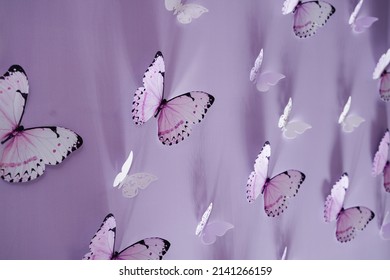 Butterflies on a purple background. Wedding decorations. Holiday decoration. Photo zone. Paper butterflies, origami