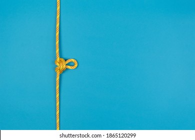 Butterfly Loop Knot With Yellow Climbing Rope On Blue Background
