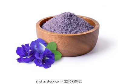Butterfly pea flower with dry blue pea powder in wooden bowl isolated on white background,