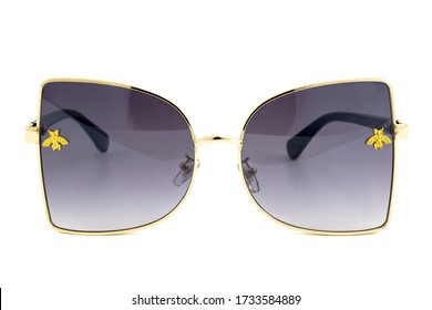 Butterfly rimless sunglasses and black gradient lenses   gold wrap around frames isolated white background  front view 