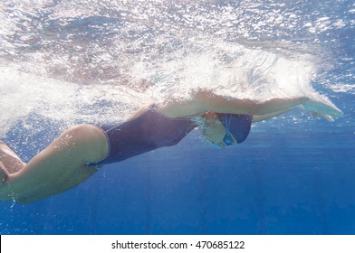 Butterfly stroke by female swimmer side view