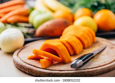 Butternut Squash Meal Preparation On Wooden Kitchen Table. Cooking Food For Traditional Thanksgiving Dinner. Making Autumn Pumpkin Soup.