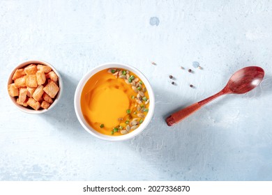 Butternut Squash Soup With Black Pepper, Overhead Flat Lay Shot On A Grey Slate Background With Copy Space