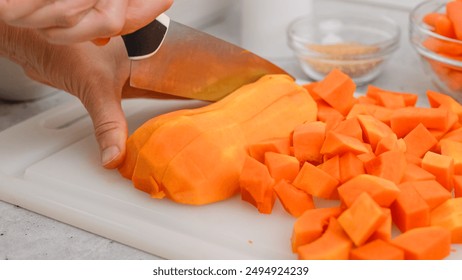 Butternut squash soup recipe. Raw vegetables close-up on the kitchen table. Peeled  and seedless butternut squash close-up on a cutting board, flat lay - Powered by Shutterstock