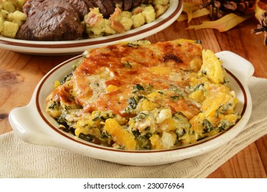 A Butternut Squash And Spinach Gratin Casserole On A Holiday Table With Roast Beef In The Background