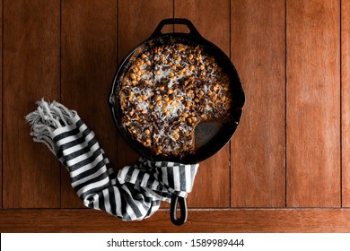 Butterscotch Coconut Skillet Cookie In Cast Iron On A Kitchen Table