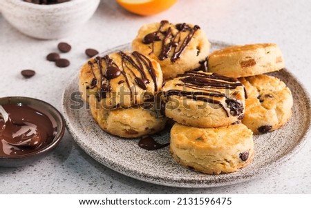 buttery gluten free orange and chocolate scones with melted chocolate glazed, sweet sour and aromatic