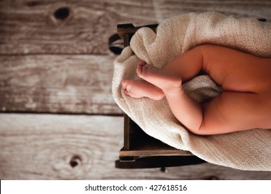 Buttocks Baby In Crib On Wood Background