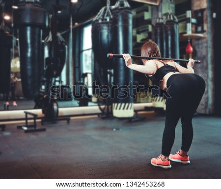 Similar – young adult trained woman concentrate at her excercise in gym