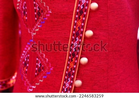 Button beads are designed to be decorated on traditional hand-woven shirts from the Northeast of Thailand.