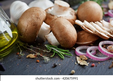 Button Mushroom With Rosemary, Onion And Peppercorns. Still Life Food Background. Healthy Food.