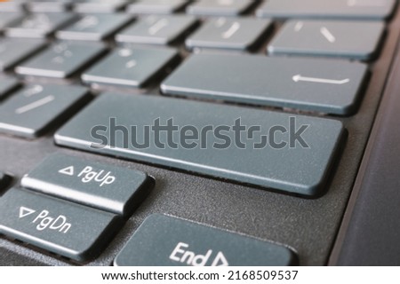 button on the black keyboard of modern ultrabook close up. caption on the button