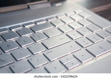 button on the gray silver keyboard of modern ultrabook close up. caption on the button
