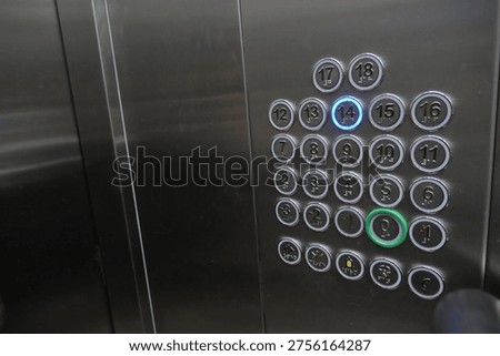 Button panel shows elevator options on a steel surface