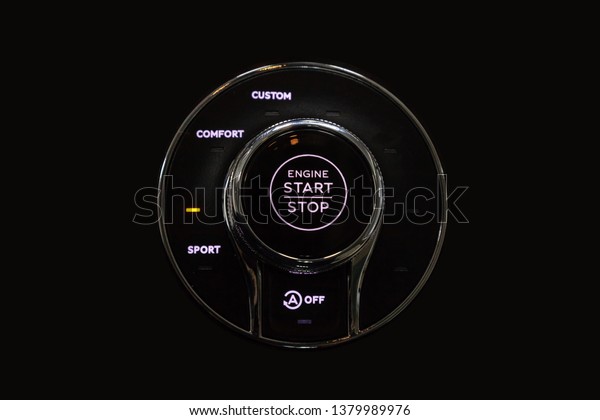 Button start\
and turn off the ignition of the car engine close-up on the\
dashboard, electric key, pressing drives the motor vehicle of\
modern design on black isolated\
background