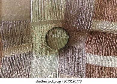 A Button In An Upholstered Couch Cushion