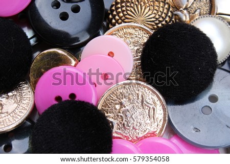 Buttons background. Colored shiny clothing button texture. Colored sewing buttons pattern concept wallpaper. Mixed colors. Studio photo texture photography.
