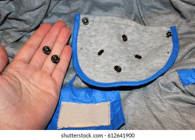 Buttons from clothes in hands