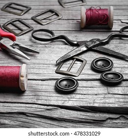 Buttons And Fasteners From Outdated Clothes On Wooden Background