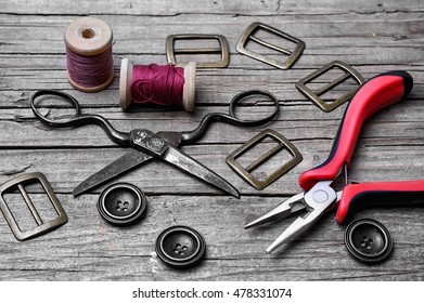 Buttons And Fasteners From Outdated Clothes On Wooden Background