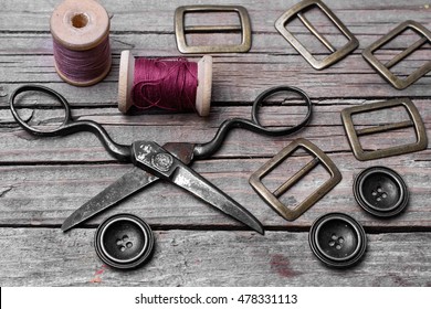 Buttons And Fasteners From Outdated Clothes On Wooden Background