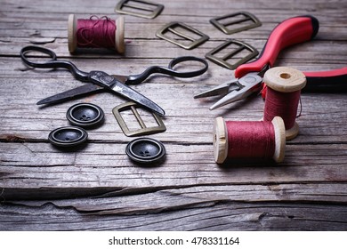 Buttons And Fasteners From Outdated Clothes On Wooden Background