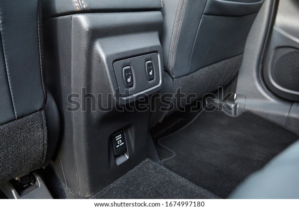 Buttons\
for heated rear seats in the car. 220 volt\
outlet