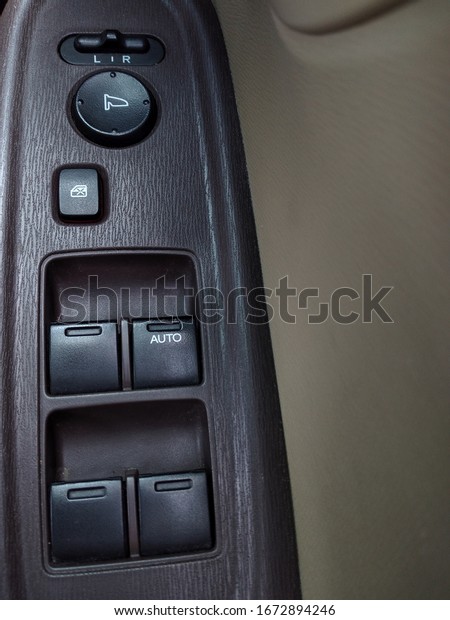 The buttons and switches are on the driver\'s side car\
door. 