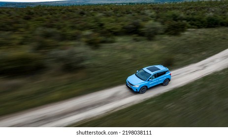 Butuceni, Moldova - 09 03 2022: Aerial Shot With Motion Blur Blue Geely Coolray On Off Road