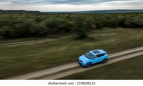 Butuceni, Moldova - 09 03 2022: Aerial Shot With Motion Blur Blue Geely Coolray On Off Road