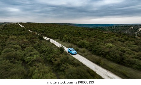 Butuceni, Moldova - 09 03 2022: Aerial Shot With Motion Blur Blue Geely Coolray On Off Road