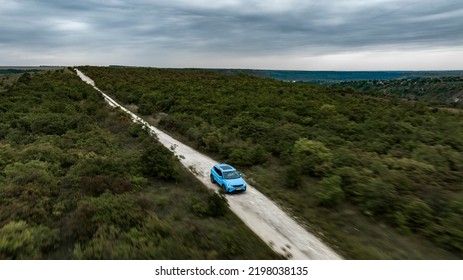 Butuceni, Moldova - 09 03 2022: Aerial Shot With Motion Blur Blue Geely Coolray On Off Road