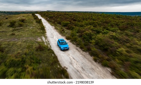 Butuceni, Moldova - 09 03 2022: Aerial Shot With Motion Blur Blue Geely Coolray On Off Road