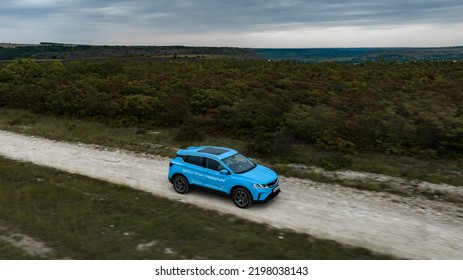 Butuceni, Moldova - 09 03 2022: Aerial Shot With Motion Blur Blue Geely Coolray On Off Road