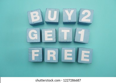 Buy 2 Get 1 Free created with cubes on blue background