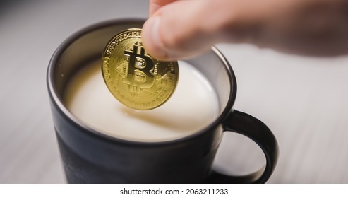 Buy the dip footage of dipping bitcoin into milk closeup