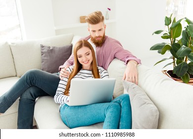 Buy email social network friends online people read news comfort cozy leisure delivery concept. Excited funky cute lovely cheerful adorable barefoot two partners watching films online in new flat