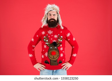 Buy Festive Clothing. Sweater With Deer. Hipster Bearded Man Wear Winter Sweater And Hat. Happy New Year. Join Holiday Party Craze And Host Ugly Christmas Sweater Party. Winter Party Outfit.