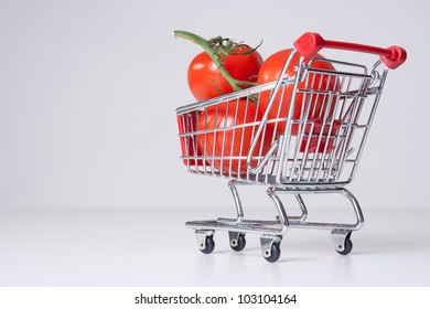 Buy Fruit And Vegetable Concept (could Be Used For Genetically Modified Food, GM Food). Shopping Cart (shopping Trolley) With Big Tomatoes.