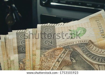 Buy new car concept background with 200 polish zloty banknote.