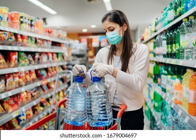 Buyer wearing a protective mask.Shopping during the pandemic.Emergency to buy list.Water supplies shortage.Panic buying during coronavirus outbreak.Preparation for a pandemic quarantine - Shutterstock ID 1679004697