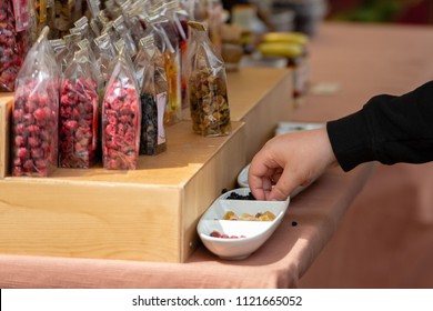 The Buyer Will Take Candy From The Bowl Of Sweets Tasting Samples.